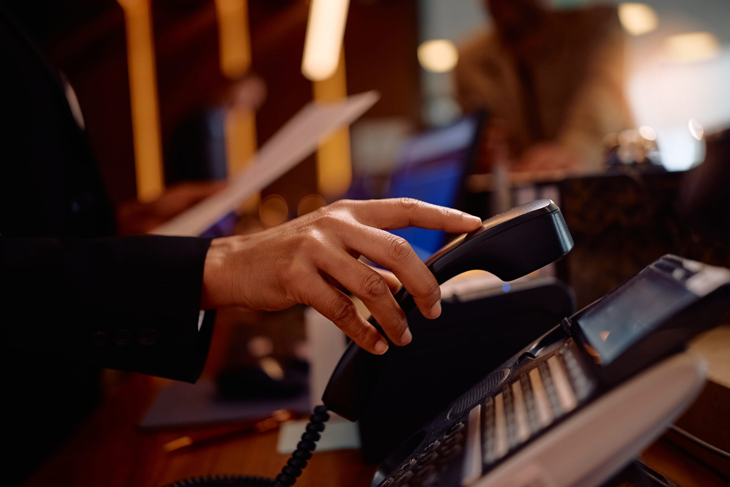 Someone putting a landline phone down after realising that he needs to check the business is ready for the PSTN switch-off in 2027.